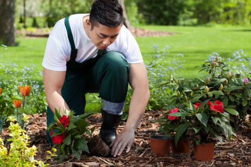 Gardening team wearing PPE including helmets and ear protection on site